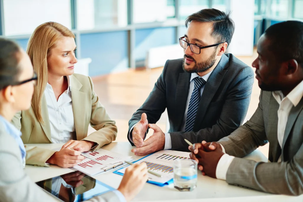 Professional advisor reviewing documents in a bright well-lit conference room with natural daylight